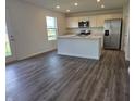 Modern kitchen equipped with stainless steel appliances, an island, and ample counter space at 11302 N Quillow Way, Monrovia, IN 46157
