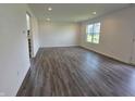 Spacious living area with luxury vinyl plank flooring, neutral walls and recessed lighting at 11302 N Quillow Way, Monrovia, IN 46157