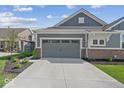 Attached two-car garage with concrete driveway and manicured landscaping at 11469 Lottie Cir, Noblesville, IN 46060