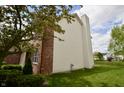 Landscaped side yard with brick and siding, with trees at 11850 Stepping Stone Dr, Fishers, IN 46037