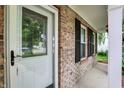 Inviting front porch featuring brick accents, decorative shutters, and charming hanging plants at 12257 Driftstone Dr, Fishers, IN 46037