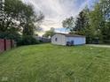 Spacious backyard featuring a detached garage with ample lawn area at 128 Coronado Rd, Indianapolis, IN 46234