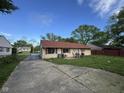 View of exterior and long driveway leading to the cozy home at 128 Coronado Rd, Indianapolis, IN 46234