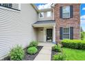 Inviting entryway showcasing a well-maintained front door and manicured landscaping at 13209 Westwood Ln, Fishers, IN 46038