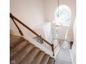 Open foyer with a grand staircase, large window, and chandelier, creating a bright and inviting entrance at 14030 Avalon East Dr, Fishers, IN 46037