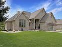 Attractive brick home featuring a well-kept lawn and elegant architectural details at 14035 Stone Key Way, Fishers, IN 46040