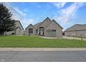 Charming single-story brick home with a well-manicured lawn and inviting front entrance at 14035 Stone Key Way, Fishers, IN 46040