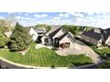 Lovely brick home featuring lush green lawn and a circular driveway at 14035 Stone Key Way, Fishers, IN 46037