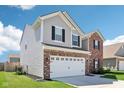 Side view of a modern two-story home featuring a gray vinyl exterior and attached garage at 1452 Bigleaf Dr, Sheridan, IN 46069