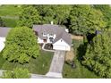 An aerial view of a charming two-story home, showcasing its mature trees, well-manicured lawn, and neighborhood at 14728 Adios Pass, Carmel, IN 46032