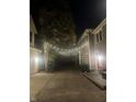 Inviting brick-paved backyard alleyway is illuminated with overhead string lights, creating a warm, cozy atmosphere at 1512 Bellefontaine St, Indianapolis, IN 46202
