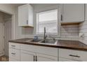 Modern kitchen featuring white cabinets, sleek hardware, and butcher block counters at 1517 Wallace Ave, Indianapolis, IN 46201