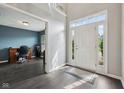Inviting foyer with hardwood floors, a bright entryway, and a glimpse into the home office at 15369 Mystic Rock Dr, Carmel, IN 46033