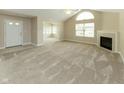 Spacious living room with fireplace, large windows, and neutral-toned carpeting at 16628 Brownstone Ct, Westfield, IN 46074