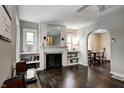 The main living area features hardwood floors and a charming fireplace with built-in shelving on both sides, offering lots of light at 1717 Hst W 10Th St, Anderson, IN 46016