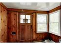 The Mud Room features wood-paneled walls and ample natural light from the adjacent windows, offering a cozy transition space at 1717 W 10Th St, Anderson, IN 46016