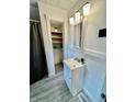 Bright bathroom with a modern vanity, stylish lighting, and a storage closet for optimal organization at 1806 Union St, Columbus, IN 47201