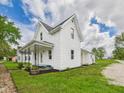Beautiful exterior view with lush lawn, showcasing the side yard, and well maintained landscaping at 225 S Carthage Rd, Charlottesville, IN 46117