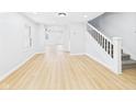 Bright living room with light flooring, neutral walls, and staircase to upper level at 225 S Carthage Rd, Charlottesville, IN 46117