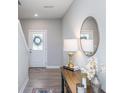 Inviting entryway featuring a decorative table with a golden lamp and round mirror at 3016 Gibbert Ln, Westfield, IN 46074