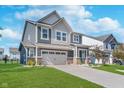 Attractive two-story home showcasing a lush green lawn and concrete driveway leading to the garage at 3016 Gibbert Ln, Westfield, IN 46074