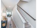 Hallway with staircase leading up, with view of living room and blue couch at 3016 Gibbert Ln, Westfield, IN 46074