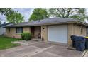 Charming single story house featuring a one car garage and well-maintained yard with green grass at 3412 Loral Dr, Anderson, IN 46013