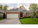Attractive home with a two-car garage, brick facade, and meticulously maintained lawn at 3438 Windy Knoll Ln, Carmel, IN 46074