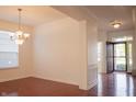 Sunlit living room with hardwood floors and traditional chandelier at 3438 Windy Knoll Ln, Carmel, IN 46074