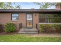 A welcoming front entrance with a secure screen door and well-maintained landscaping at 3605 Redfern Dr, Indianapolis, IN 46237