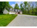 Beautiful two-story home featuring an attached garage, lush green lawn, and mature trees at 3660 S Conservation Club Rd, Morgantown, IN 46160