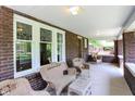 Inviting front porch with wicker furniture, brick columns, and large windows at 3744 S Meridian St, Indianapolis, IN 46217