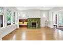 Bright living room with a tiled fireplace, hardwood floors, and an eye-catching window seat at 3744 S Meridian St, Indianapolis, IN 46217