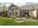 Backyard features a brick home with a patio, garden beds, and a well-maintained grassy area at 4281 Cairo Way, Avon, IN 46123
