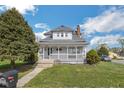 Charming two-story home with a welcoming front porch and well-maintained lawn, with mature trees at 4429 Iowa St, Clayton, IN 46118