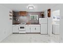 Well-lit kitchen with stainless steel appliances, tile backsplash, and white cabinetry at 4721 E Morris St, Indianapolis, IN 46203
