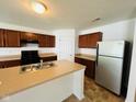 Well-equipped kitchen with stainless steel appliances, sleek countertops, and wood cabinets at 5313 Brandywine Dr, Whitestown, IN 46075