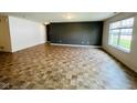Bright and spacious living area with luxury vinyl tile and modern paint at 5313 Brandywine Dr, Whitestown, IN 46075