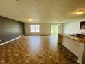 Bright, spacious living room features modern vinyl floors and a large window at 5313 Brandywine Dr, Whitestown, IN 46075