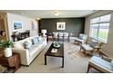 Bright living room area features a modern sofa, accent chairs, and a dining table at 5313 Brandywine Dr, Whitestown, IN 46075