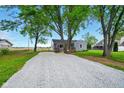 Inviting home featuring a spacious gravel driveway and mature trees at 532 W 1050 N, Fortville, IN 46040