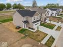 Aerial view of homes in a residential community featuring well-maintained lawns and modern architecture at 558 Plowman Dr, Shelbyville, IN 46176