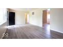 Open living room with light-colored walls and modern flooring, bathed in natural light at 5605 Glencoe St, Indianapolis, IN 46226