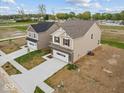 Aerial view of charming homes featuring brick and siding, complemented by a spacious two-car garage and green lawns at 564 Plowman Dr, Shelbyville, IN 46176