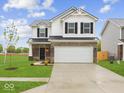 Charming two-story home with a well-maintained lawn and attached two-car garage at 576 Plowman Dr, Shelbyville, IN 46176