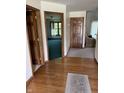Inviting hallway with hardwood floors and a view into the adjacent rooms at 636 Mallards Xing # 2-A, Martinsville, IN 46151