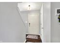 Inviting entryway with hardwood floors, a coat closet, and stairs leading to the upper level at 6624 Lakestone Ct, Indianapolis, IN 46237