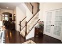 Welcoming foyer features hardwood floors, a staircase with white spindles, and elegant decor at 665 Featherstone Dr, Westfield, IN 46074