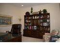Well-decorated office space with built-in bookshelf, leather chair, and ample natural light at 665 Featherstone Dr, Westfield, IN 46074