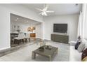 Open-concept living room with modern decor, hardwood floors, and a seamless flow into the dining area and kitchen at 6816 Park Square Dr # C, Avon, IN 46123